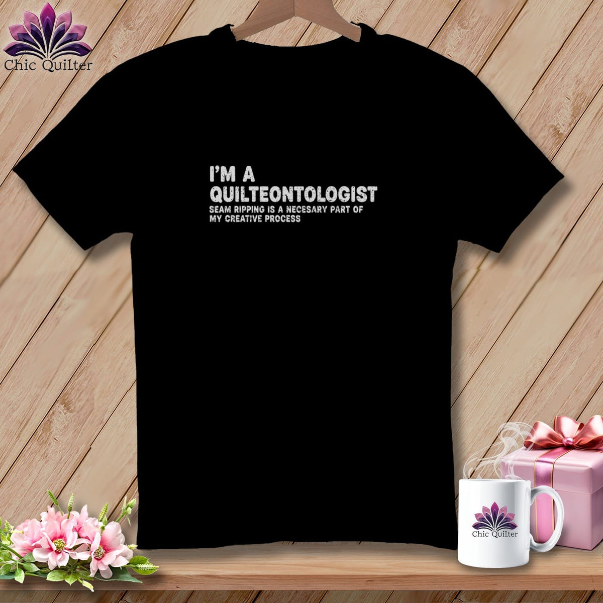 Black t-shirt with "I'M A QUILTEONTOLOGIST" text and floral logo.