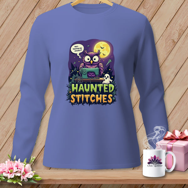 Purple long-sleeve shirt with an owl and sewing machine graphic saying "Haunted Stitches."