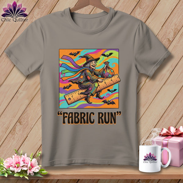 Witch on a ruler with a fabric bag, "Fabric Run" text below.