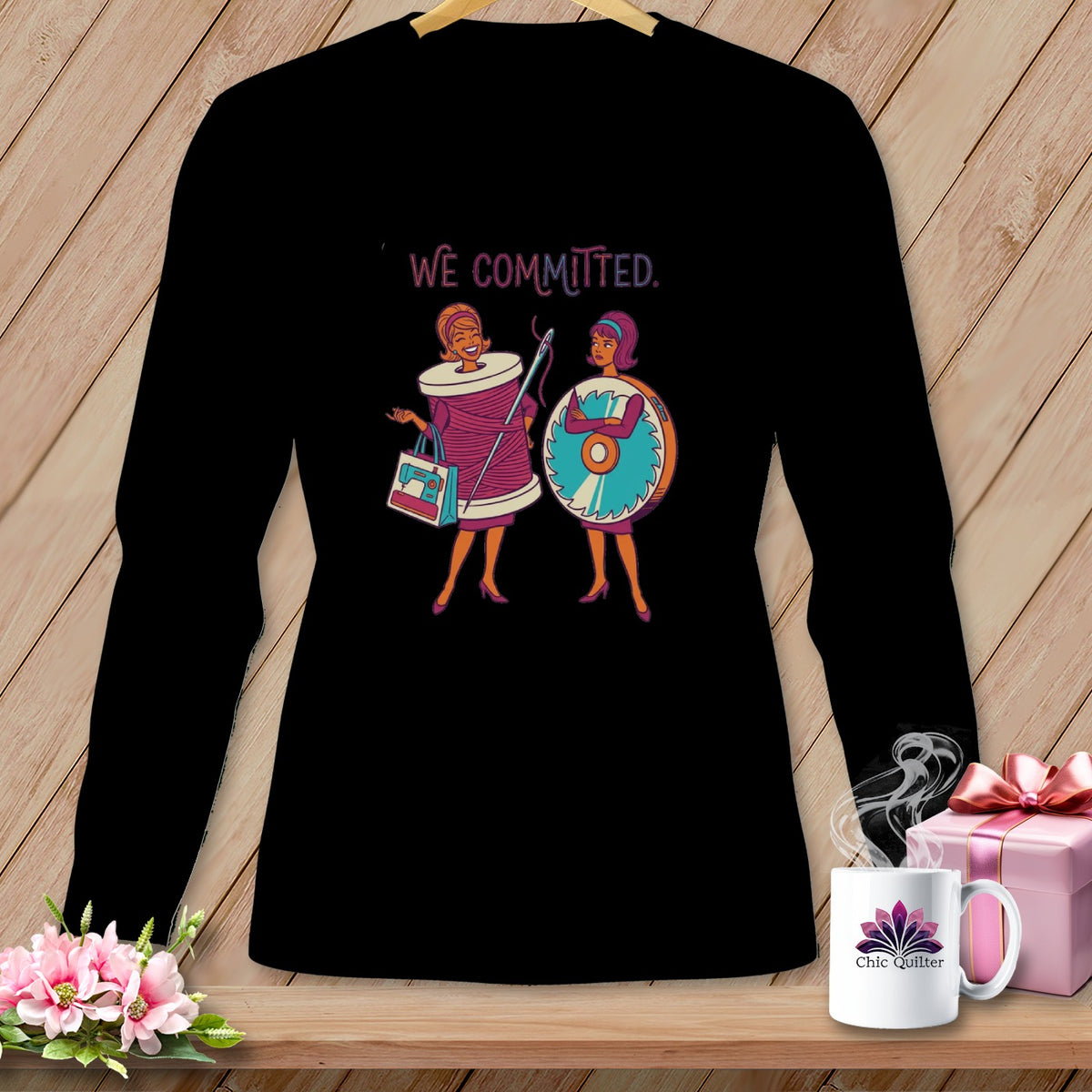 Black long sleeve shirt with "WE COMMITTED." text and sewing graphic.