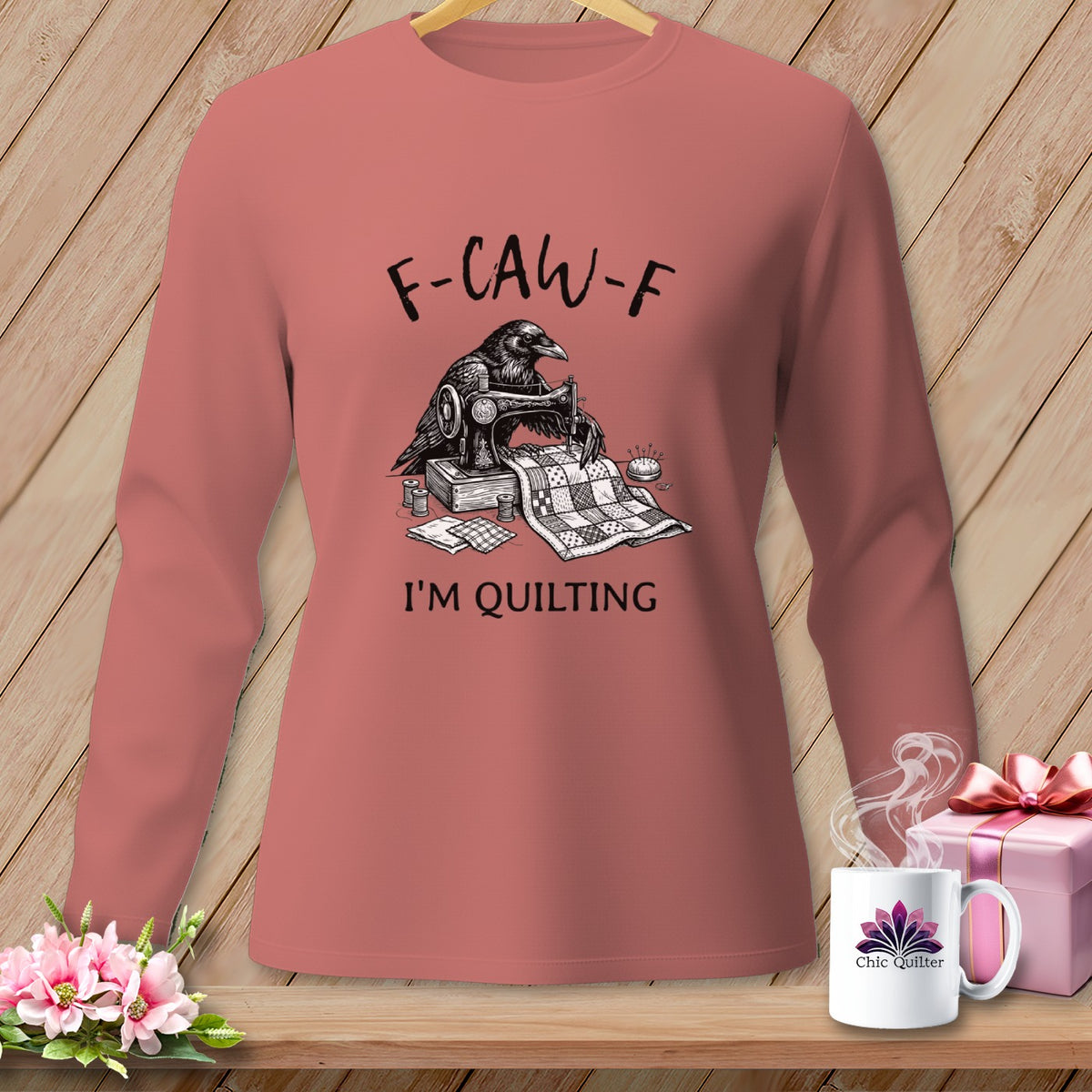 Long-sleeve shirt with crow sewing a quilt, text "F-CAW-F I'M QUILTING".