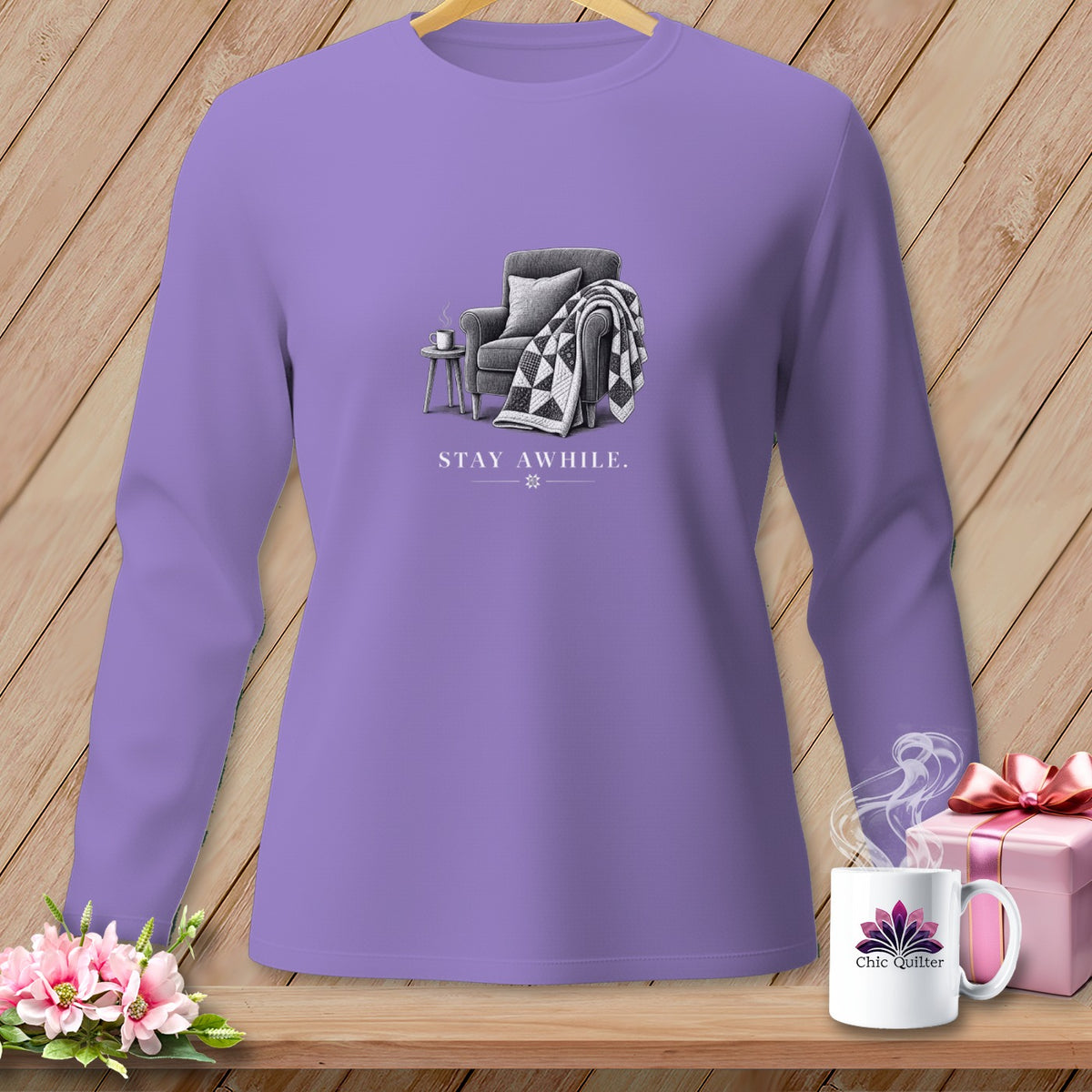 Purple long-sleeve shirt with "STAY AWHILE." text and armchair graphic.