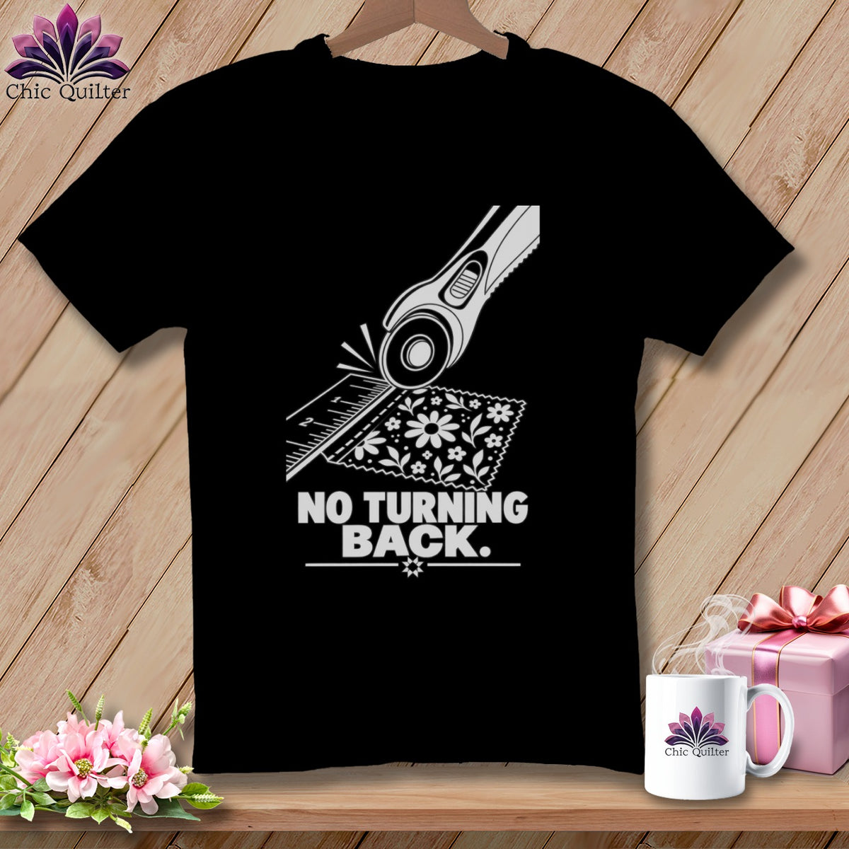 Black t-shirt with rotary cutter, ruler, floral fabric and text "NO TURNING BACK".