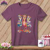 A plum t-shirt featuring a cartoon graphic of three colorful birds wearing glasses and flower crowns.