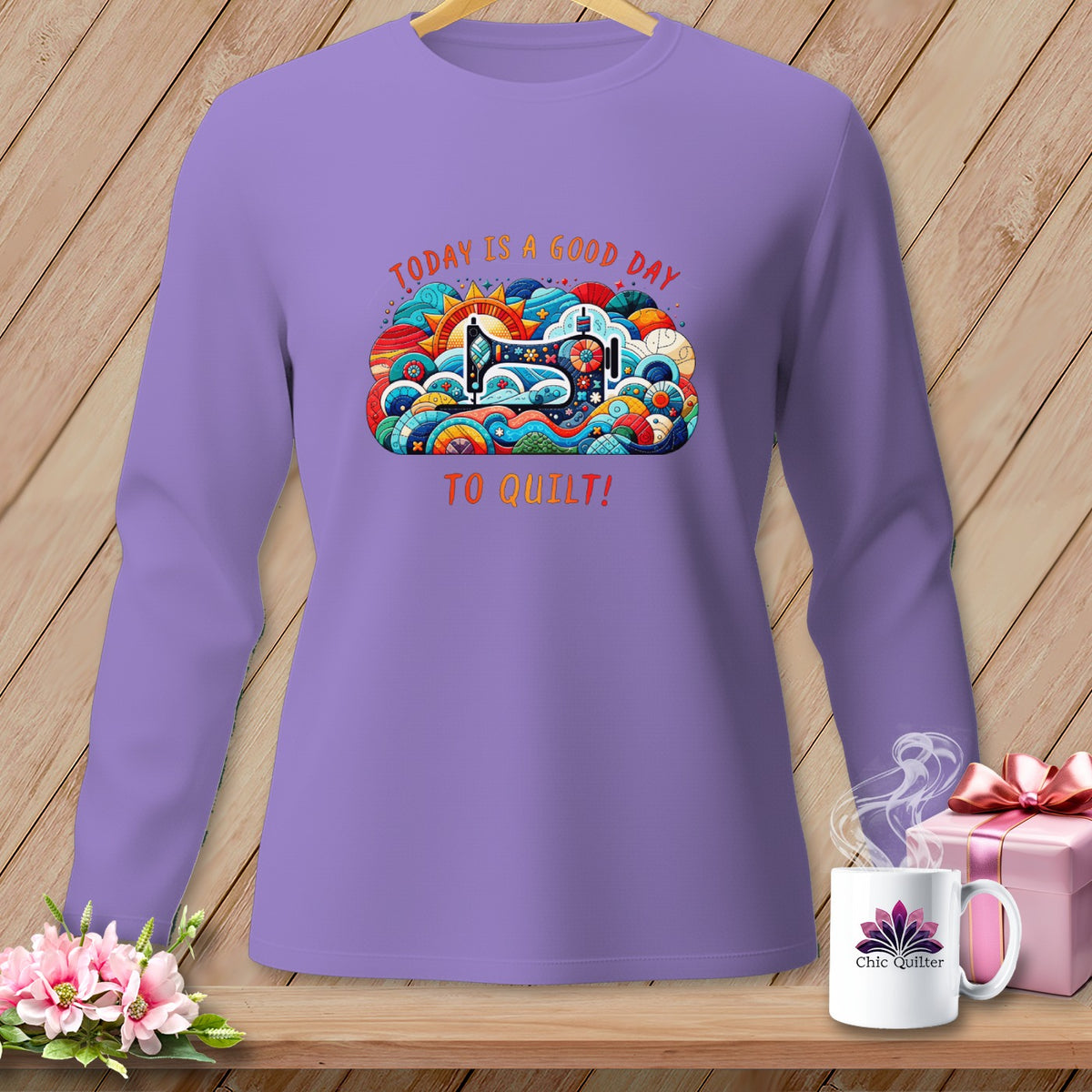 Purple long-sleeve shirt with colorful sewing machine graphic and text.