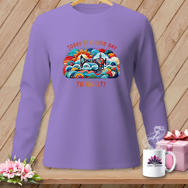 Purple long-sleeve shirt with colorful sewing machine graphic and text.