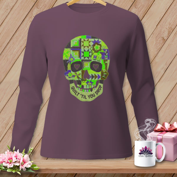 Purple long-sleeved shirt with a patchwork skull design and "Quilt 'til You Drop" text.