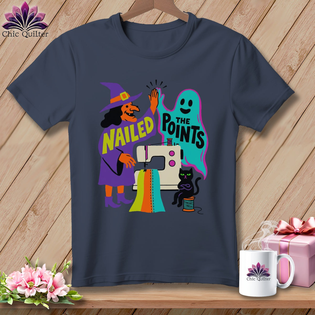 Witch and ghost high-five over sewing machine with text "NAILED THE POINTS".