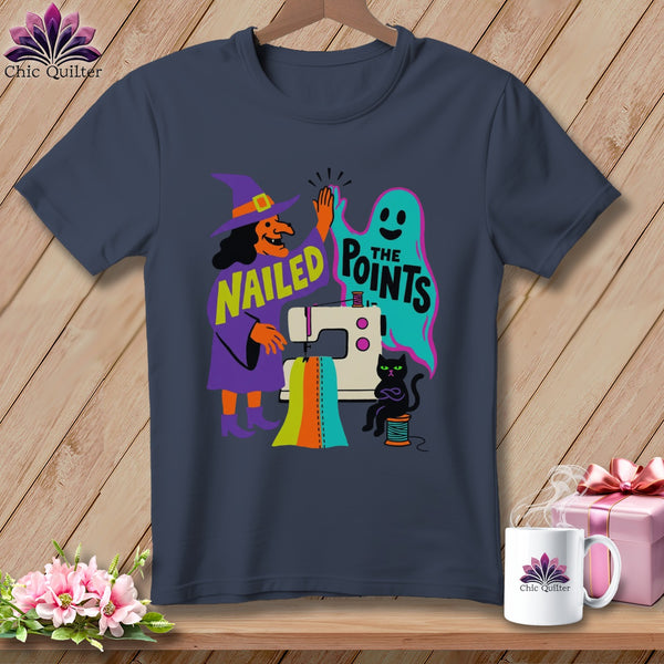 Witch and ghost high-five over sewing machine with text "NAILED THE POINTS".
