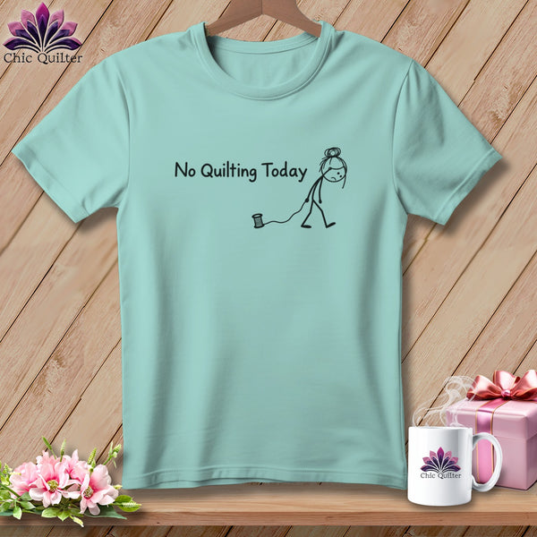 Light blue t-shirt with a stick figure and spool of thread, saying "No Quilting Today".