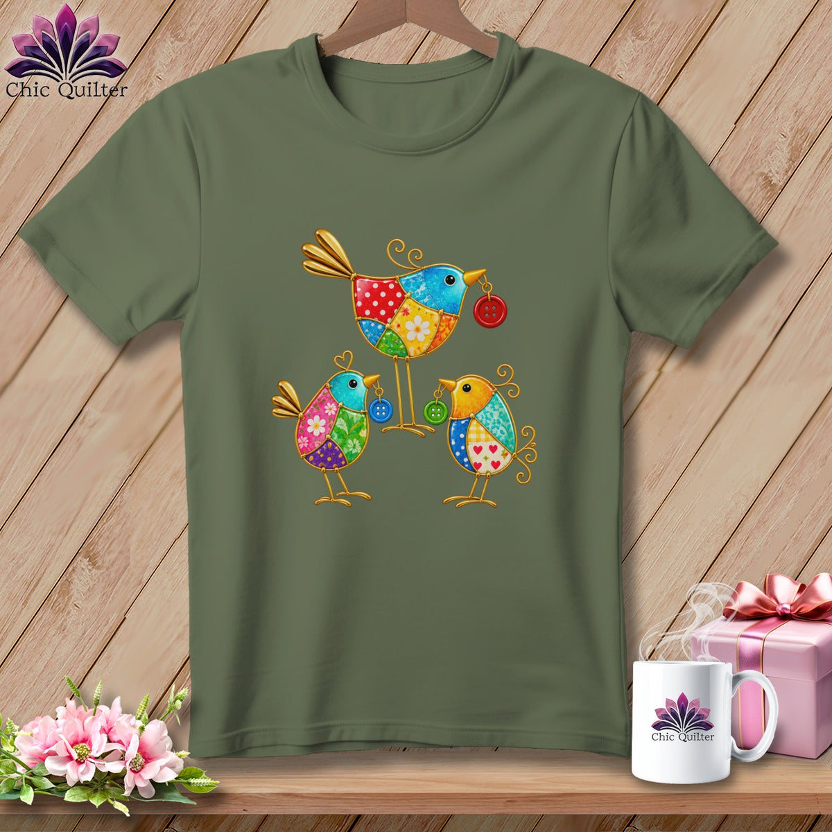 Olive green short-sleeved t-shirt featuring a colorful patchwork bird graphic on a wooden background.