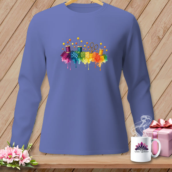 Lavender long-sleeve shirt with watercolor sewing notions and rainbow fabric splatters.