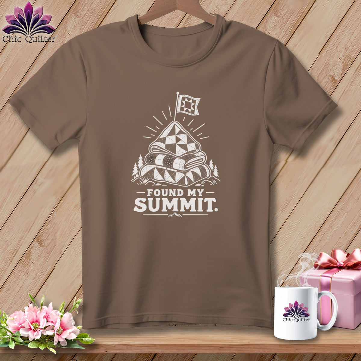 Brown t-shirt with a white graphic of stacked quilts topped with a flag, text reads "FOUND MY SUMMIT."