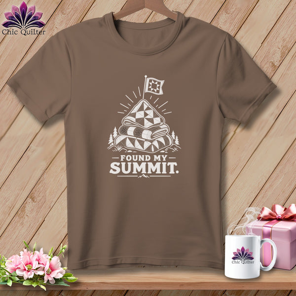 Brown t-shirt with a white graphic of stacked quilts topped with a flag, text reads "FOUND MY SUMMIT."