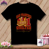 Black t-shirt featuring a San Francisco quilter graphic with fabric rolls, a crate, and measuring tape.