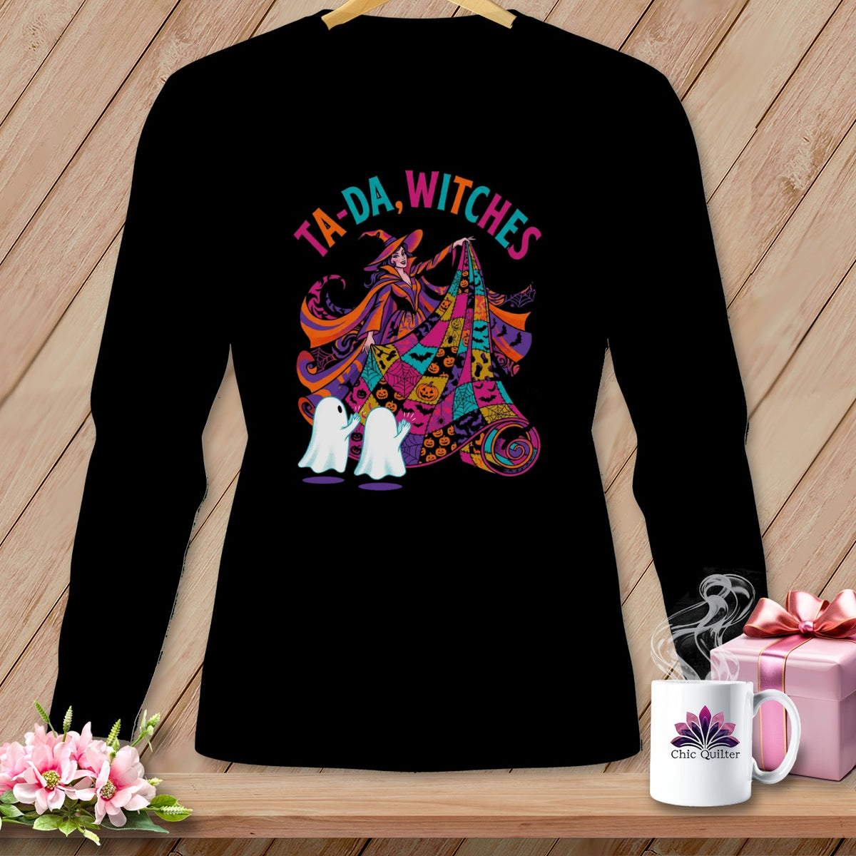 Black long-sleeve shirt with a colorful Halloween witch and ghosts graphic.