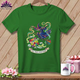 Green t-shirt with a witch flying a broomstick, surrounded by quilting items and text.