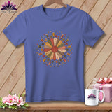 Purple t-shirt with a dresden plate quilt design and sewing notions.