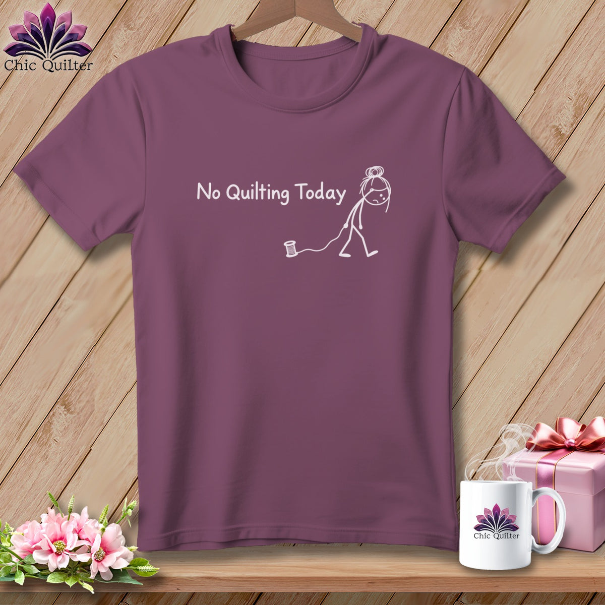 Plum t-shirt with white text and graphic of a tired stick figure with a spool of thread.