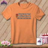 Orange t-shirt on a wooden background, featuring the text 
