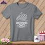Gray t-shirt with white graphic of rotary cutter, fabric stack, and text "Questionable Cuts".