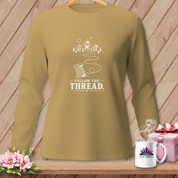 Long sleeve shirt with "Follow the Thread" and mountain quilt graphic.