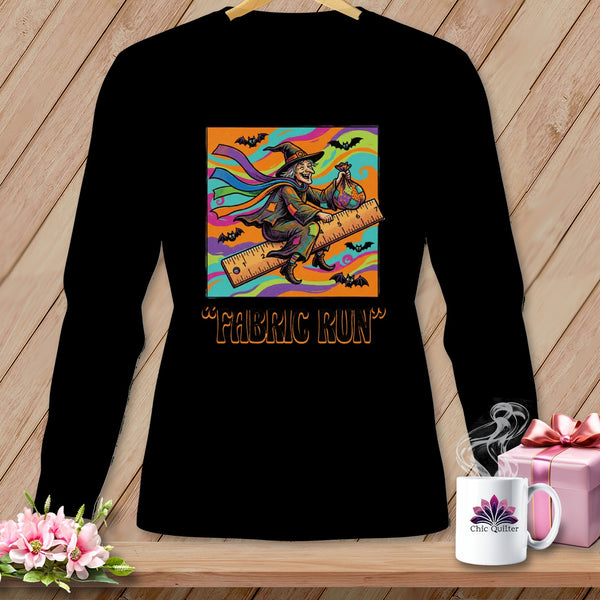 Black long-sleeve shirt with a graphic of a witch riding a ruler, text "FABRIC RUN".