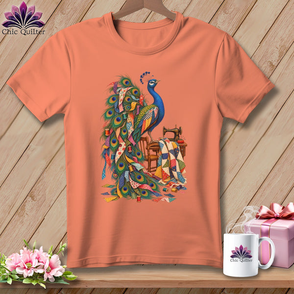 Peacock with sewing machine and quilt on a peach t-shirt.