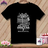Black t-shirt with stack of fabric, scissors, and text 