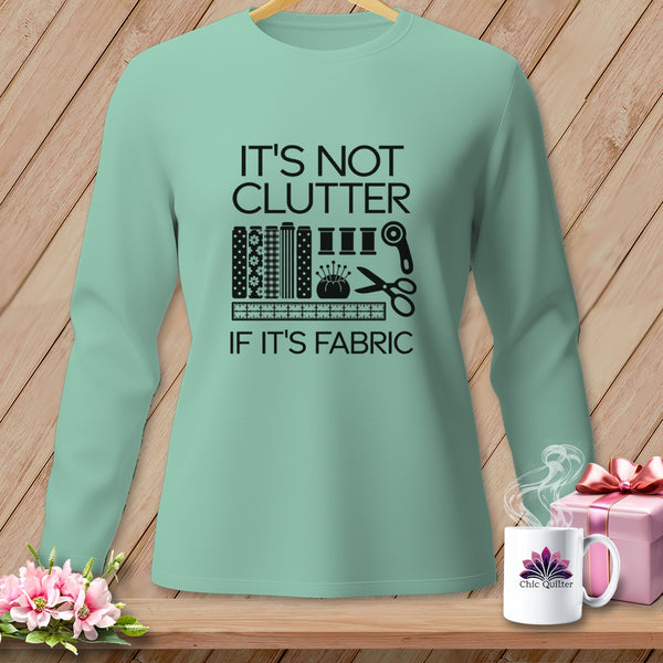 Long-sleeve shirt with "It's Not Clutter If It's Fabric" text and sewing graphics.