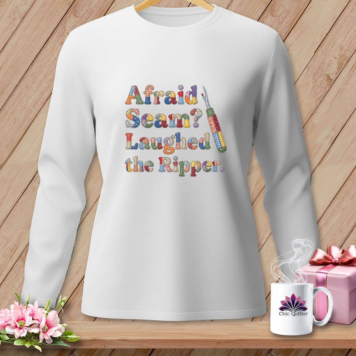 White sweatshirt with "Afraid Seam? Laughed the Ripper." text and sewing tool graphic.