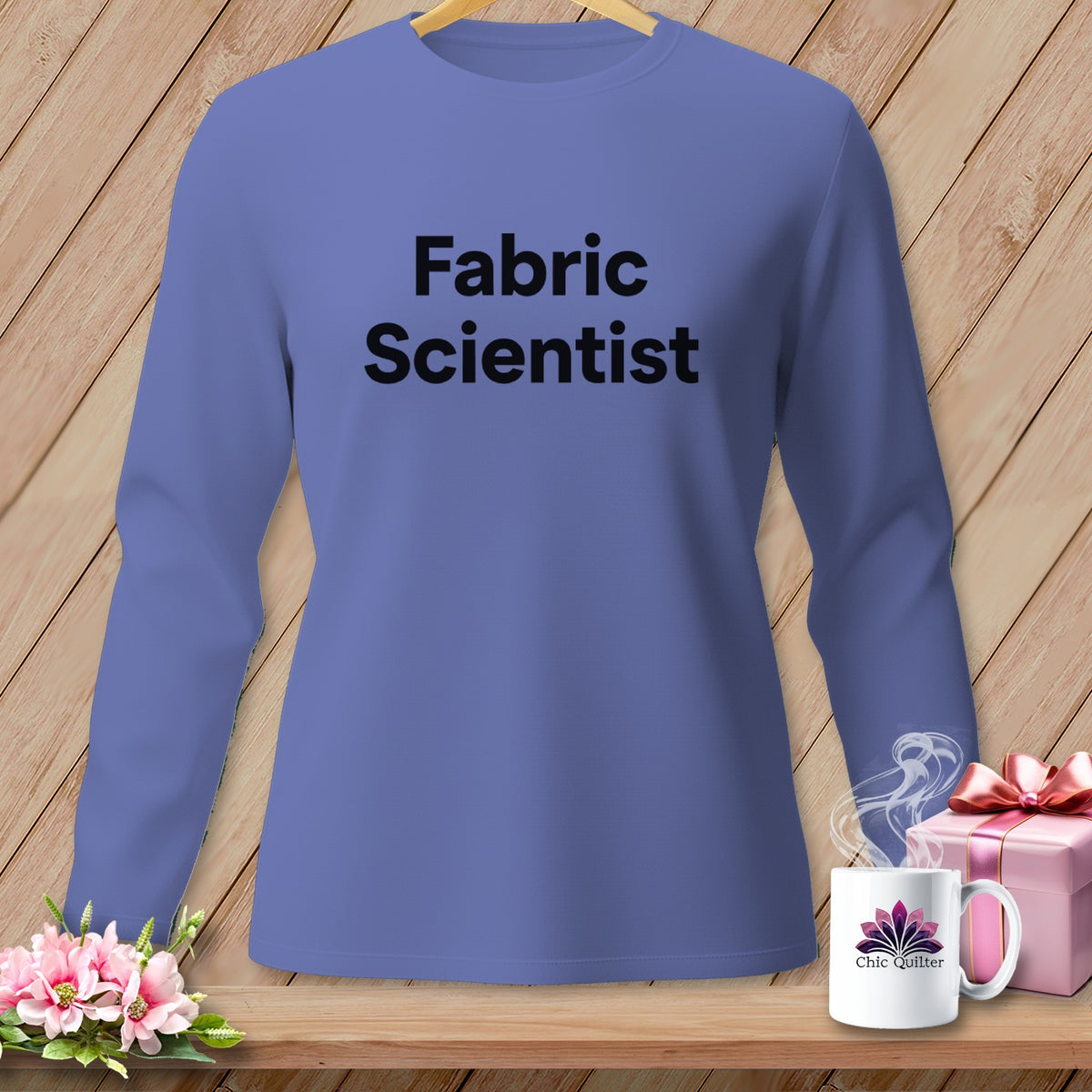 Purple long-sleeve shirt with "Fabric Scientist" text, next to a mug and gift.