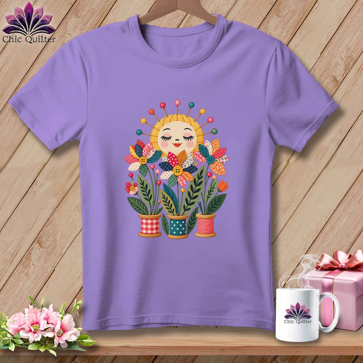 A purple t-shirt featuring a graphic of a smiling sun and colorful fabric flowers in spools.