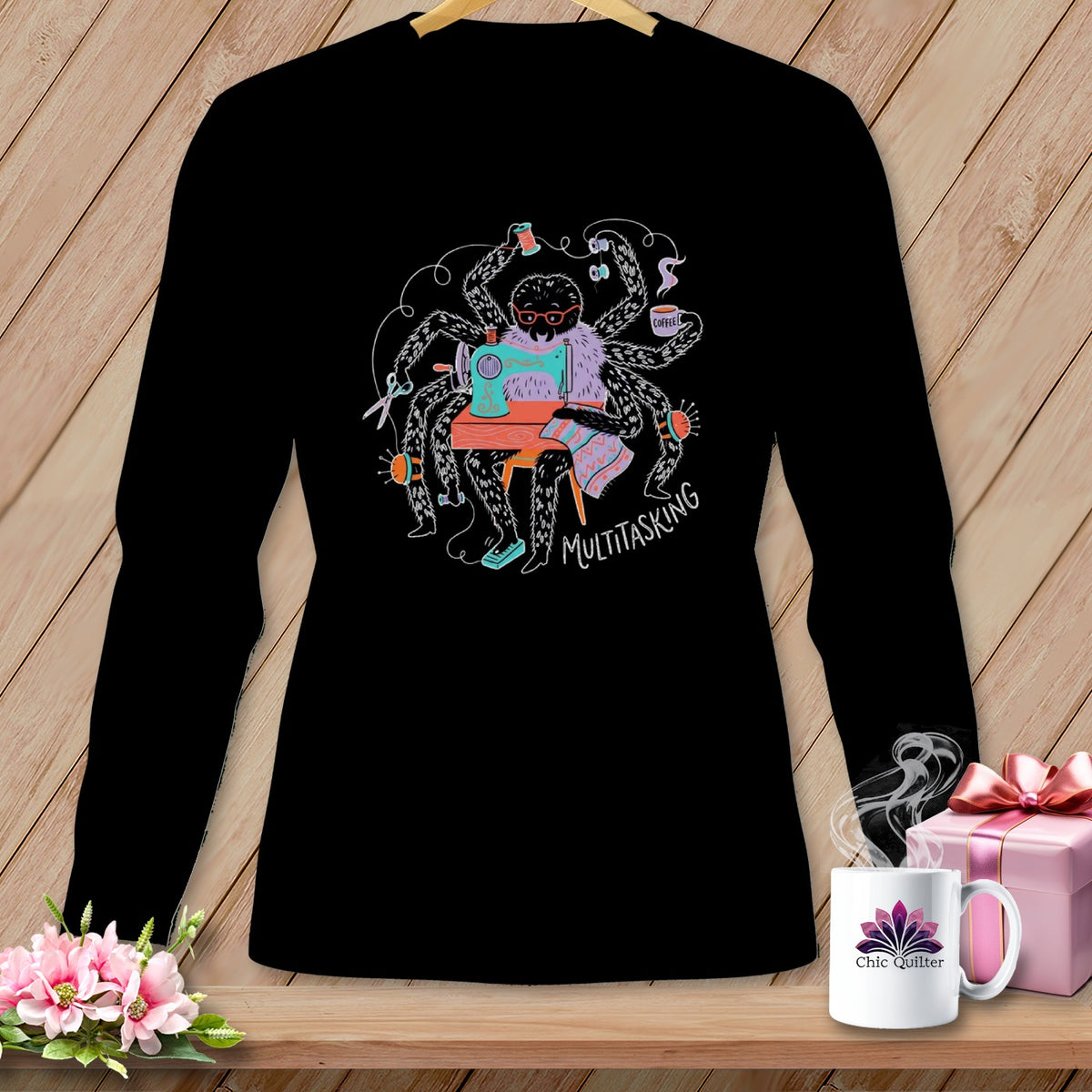 Black long-sleeve shirt with a graphic of a spider sewing, labeled "MULTITASKING".