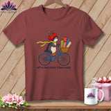 Penguin on a bicycle with fabric rolls, wearing a tomato hat, and text 