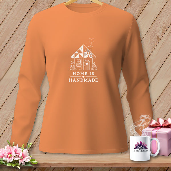 Orange long-sleeve shirt with white house graphic and text "HOME IS HANDMADE".