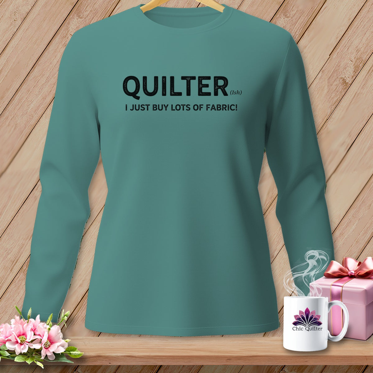 Teal long-sleeve shirt with "QUILTER (ish) I JUST BUY LOTS OF FABRIC!" text.