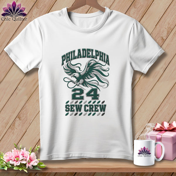 White t-shirt with a green graphic featuring an eagle, the number 24, and text reading Philadelphia Sew Crew.