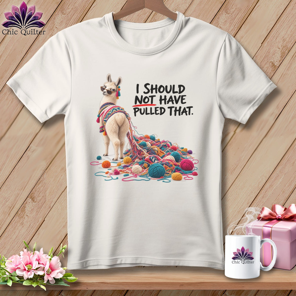 White t-shirt with a llama and yarn graphic, text reads "I SHOULD NOT HAVE PULLED THAT."