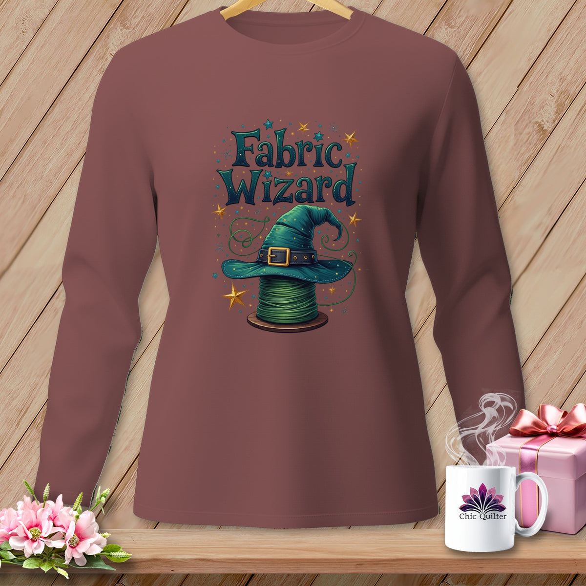 Long-sleeve shirt with a witch hat on a spool of green thread design.