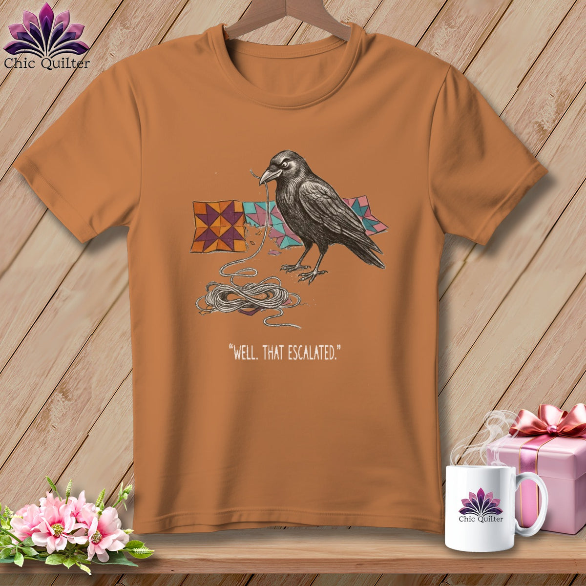 T-shirt with raven tangled in string next to quilt pieces and text.