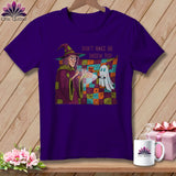 Purple t-shirt with a witch and ghost graphic and text 