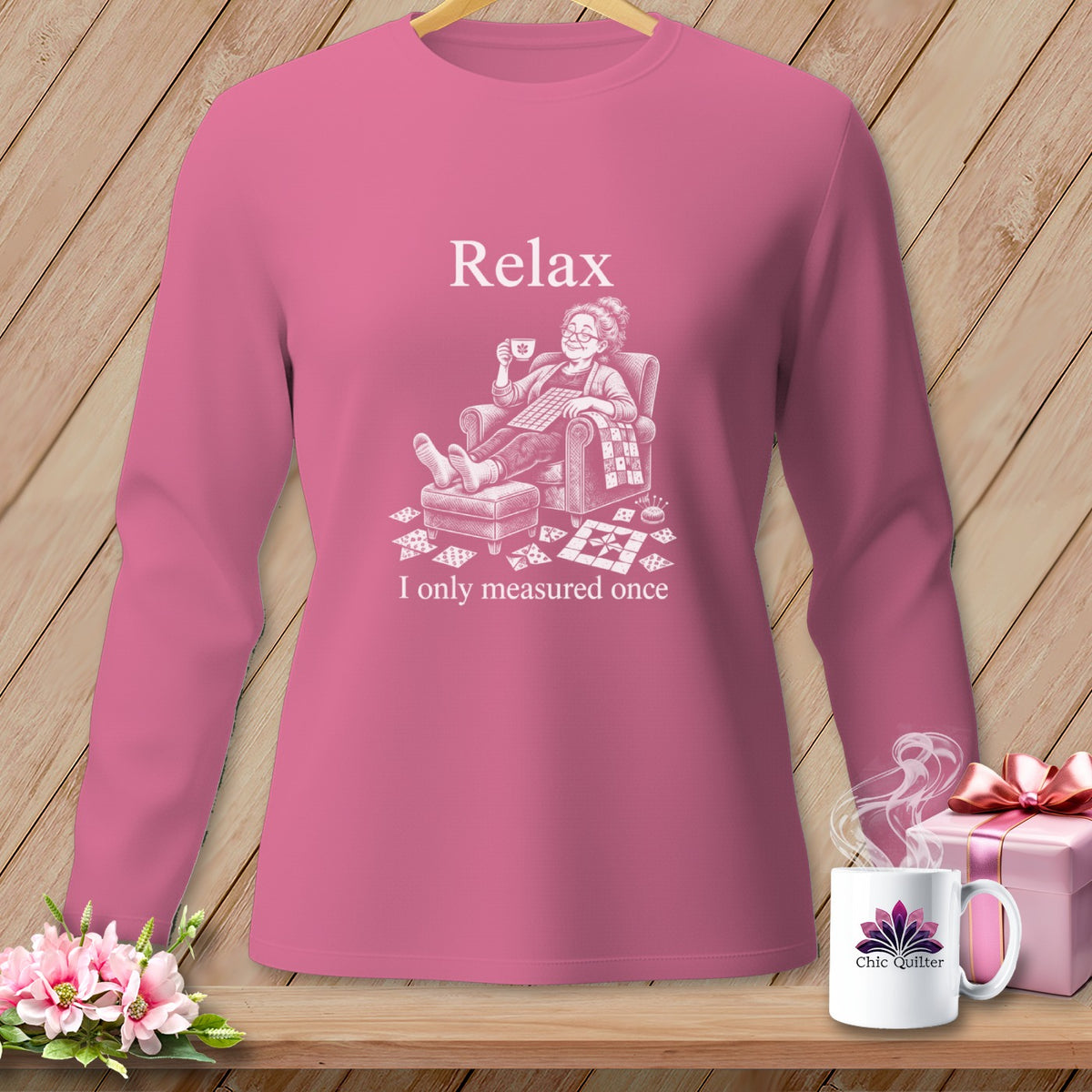 Pink sweatshirt with "Relax I only measured once" quilting graphic.