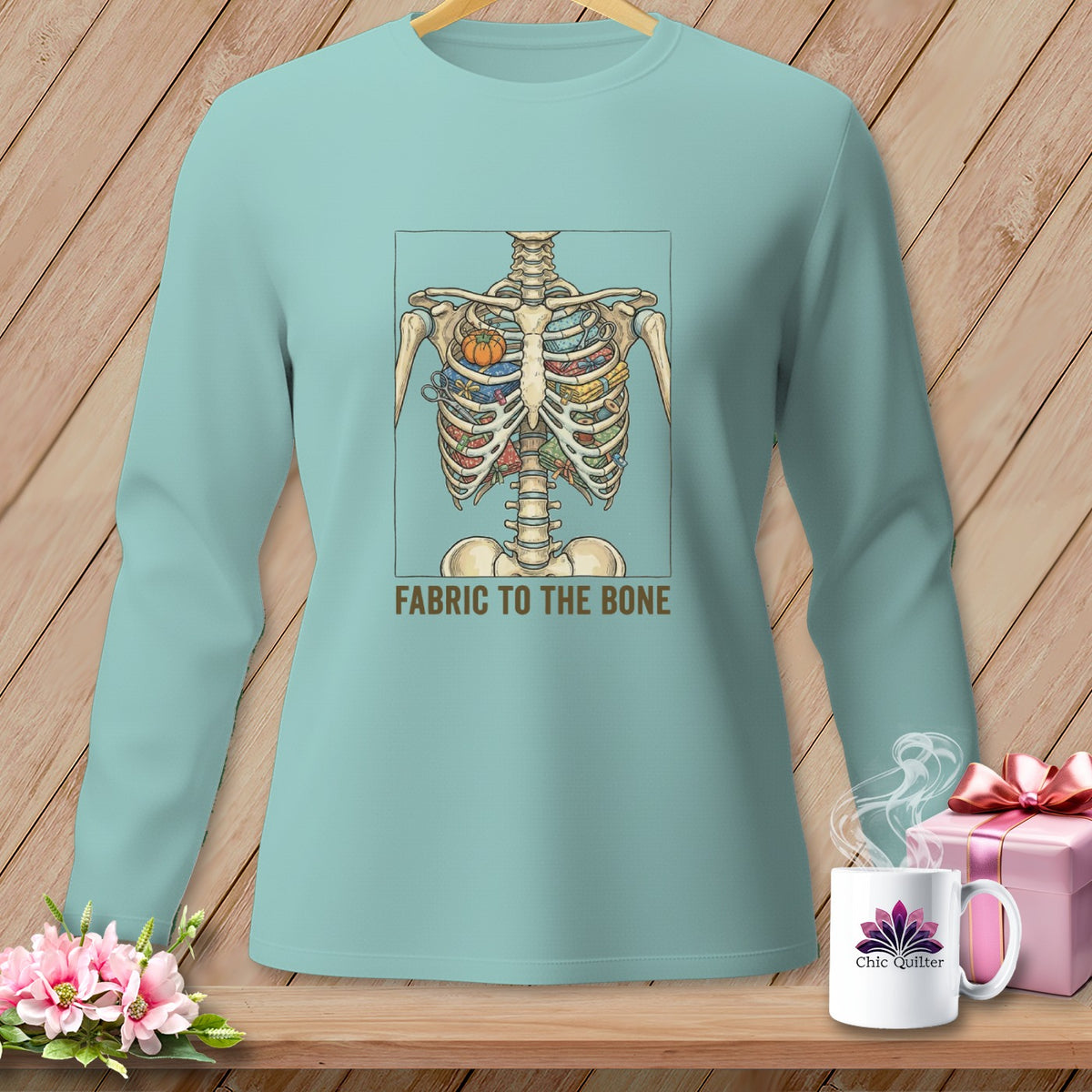 Light blue long-sleeved shirt with skeleton torso filled with fabric and text "FABRIC TO THE BONE".