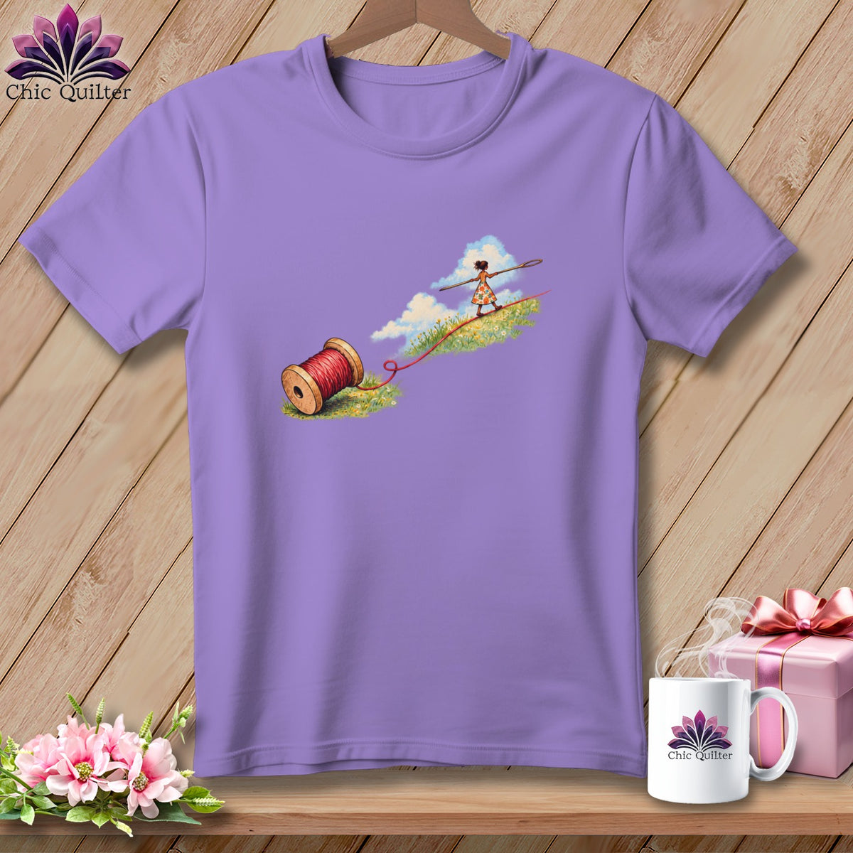 A purple t-shirt featuring a whimsical illustration of a girl tightrope walking on red thread.