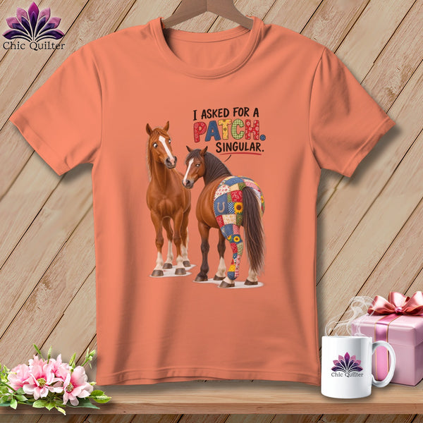 Orange t-shirt with two horses and the text "I asked for a PATCH SINGULAR."