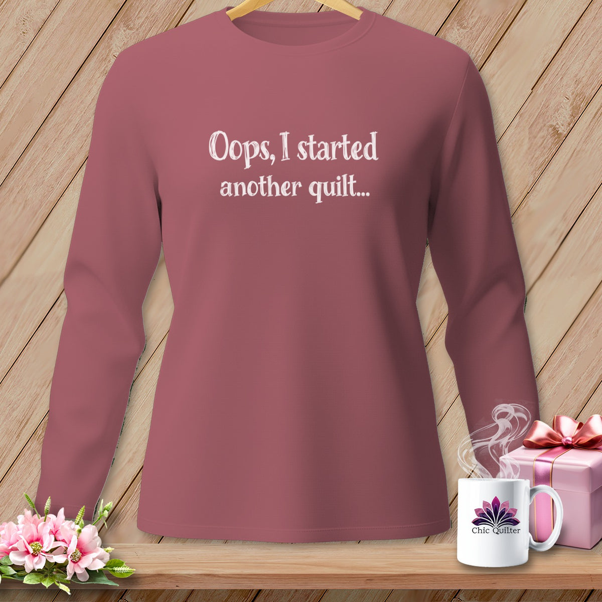 Dusty rose long-sleeve shirt with white text "Oops, I started another quilt...".
