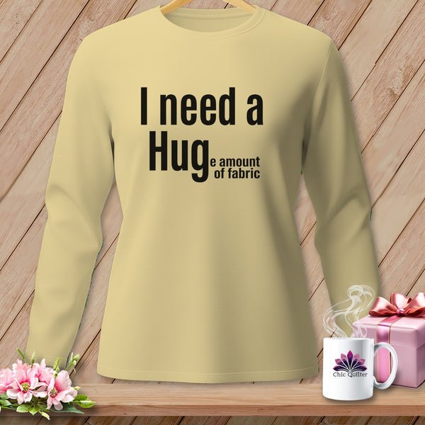 Light yellow long-sleeved shirt with black text reading "I need a Hug, e amount of fabric".