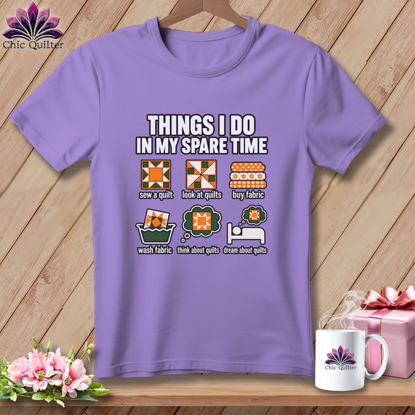 A purple t-shirt featuring a quilting-themed graphic and text on a wooden surface.