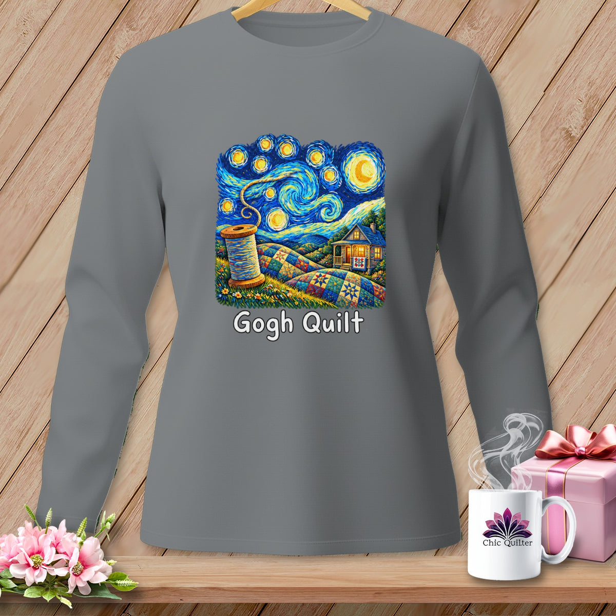 Grey long-sleeved shirt with a "Gogh Quilt" design featuring a spool of thread and a patchwork landscape under a starry sky.